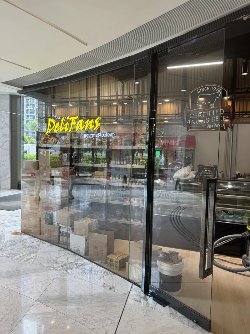 DeliFans shopfront behind glass walls, with shelves of groceries inside