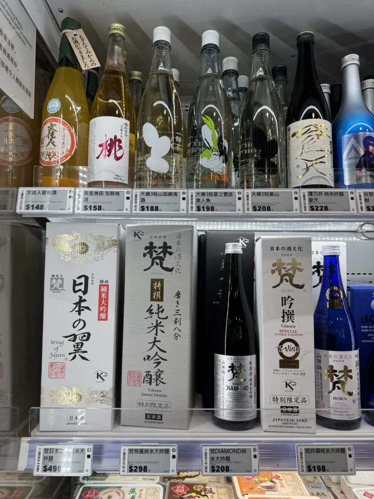 Electronic shelf labels on chiller shelves of Japanese sake bottles